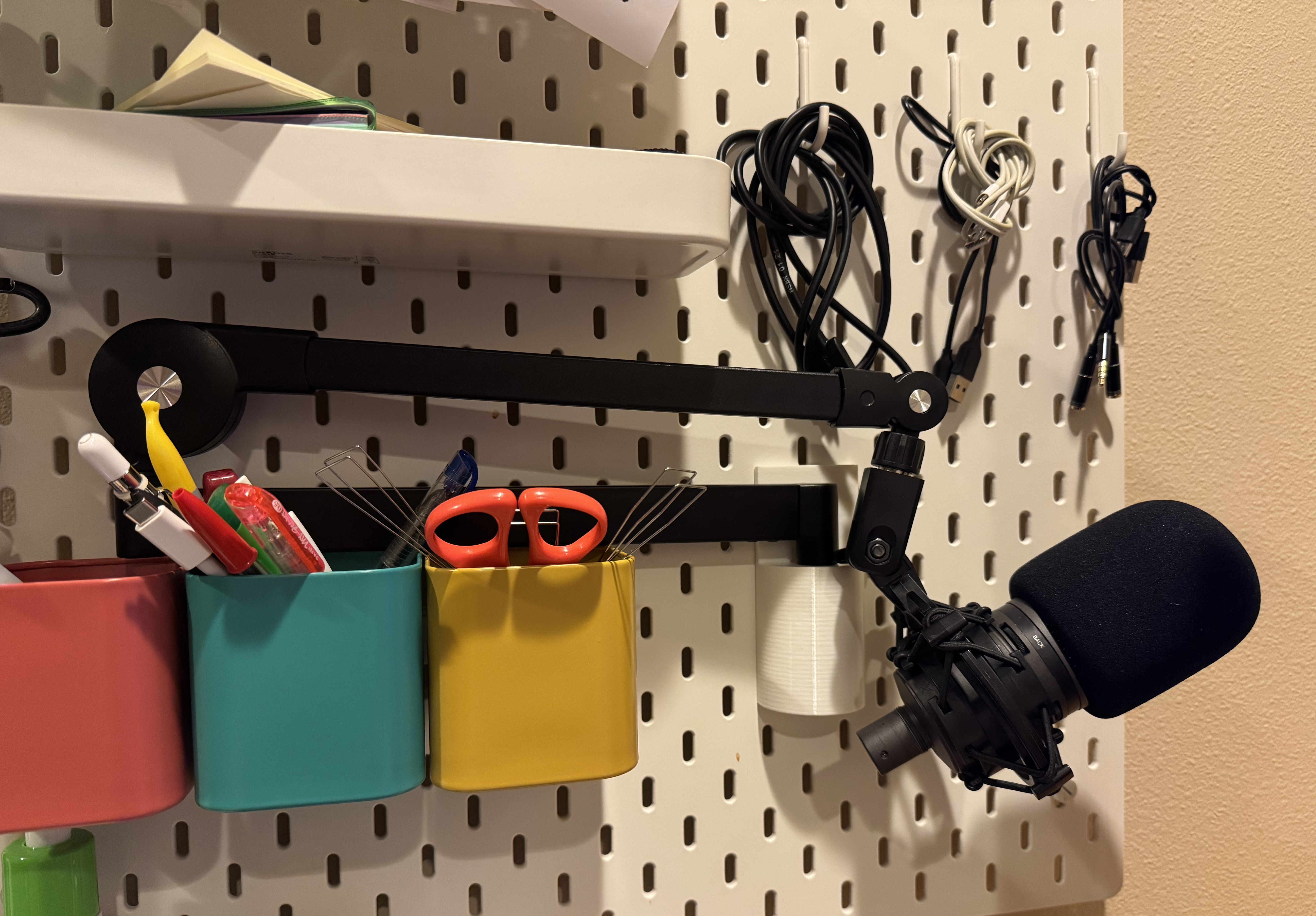 3D printed mic holder attached to Ikea skadis pegboard.